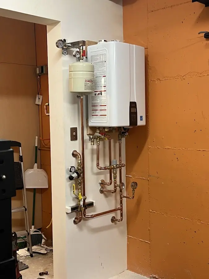 Plumbing technician inspecting water heater connections in Bountiful